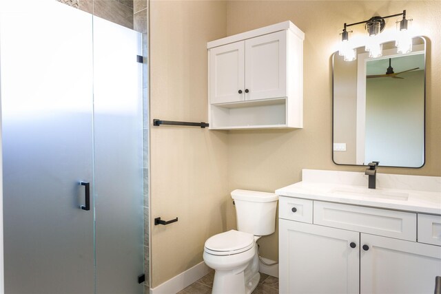114 Pheasant Ridge Ct, Polson, MT 59860 - bathroom featuring toilet, a shower stall, vanity, a ceiling fan, and baseboards
