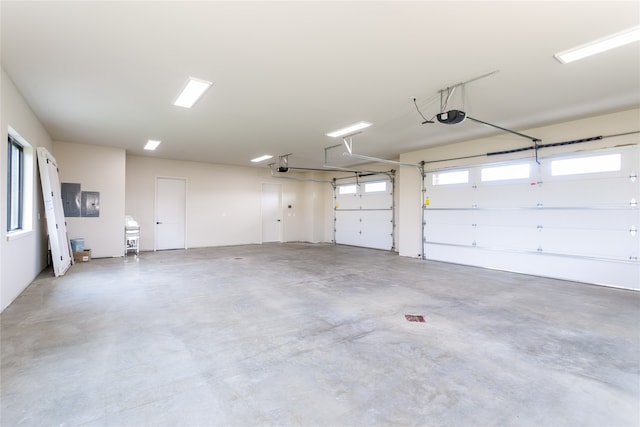 garage with a garage door opener and electric panel