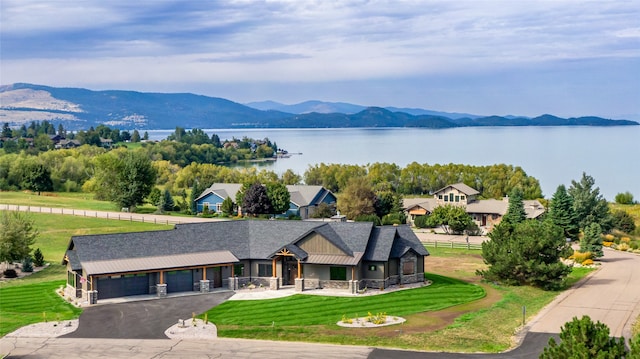 drone / aerial view with a water and mountain view