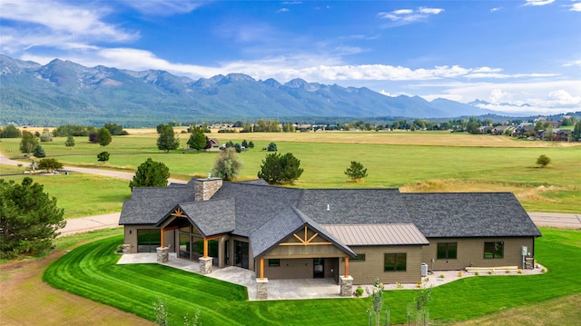 exterior space with a mountain view and a front yard