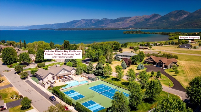 birds eye view of property with a water and mountain view