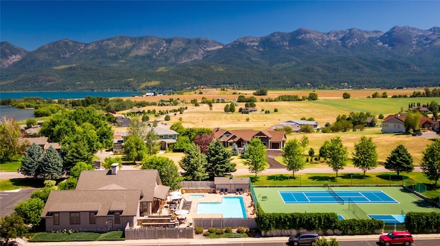 drone / aerial view featuring a water and mountain view