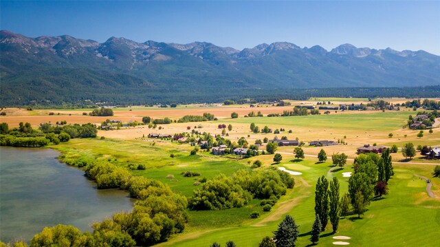 drone / aerial view featuring a water and mountain view