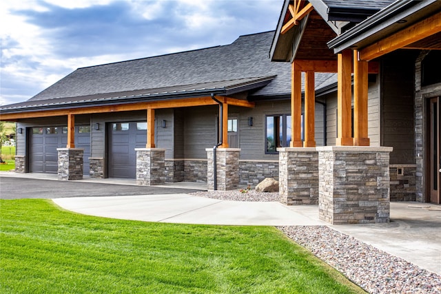 view of property exterior with a garage and a lawn