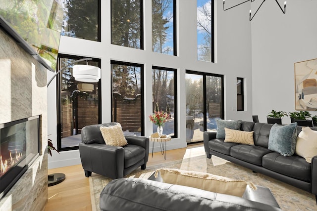 9 Cedar Pointe Loop, Columbia Falls, MT 59912 - living area featuring a high ceiling, an inviting chandelier, a high end fireplace, and light wood-style floors