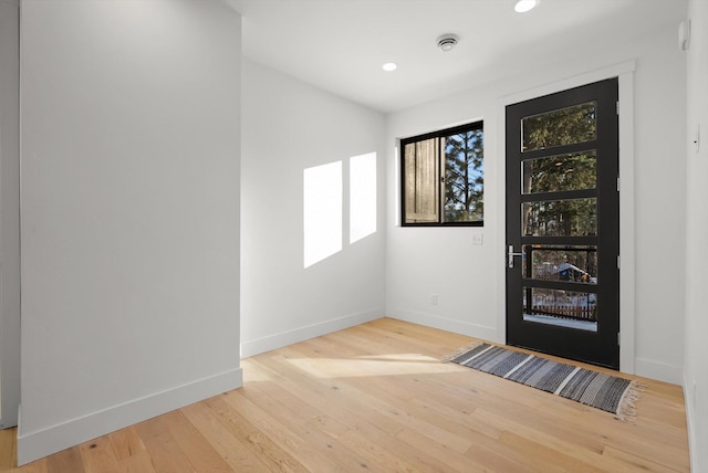 entryway with baseboards, wood finished floors, and recessed lighting