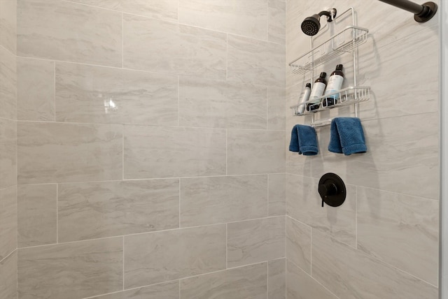 interior details with a tile shower