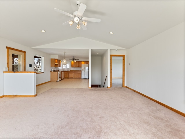 unfurnished living room with light carpet, ceiling fan, and vaulted ceiling