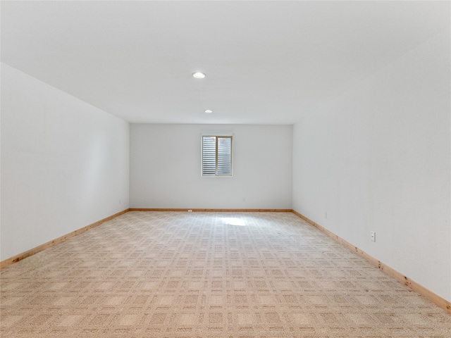 unfurnished room with light carpet