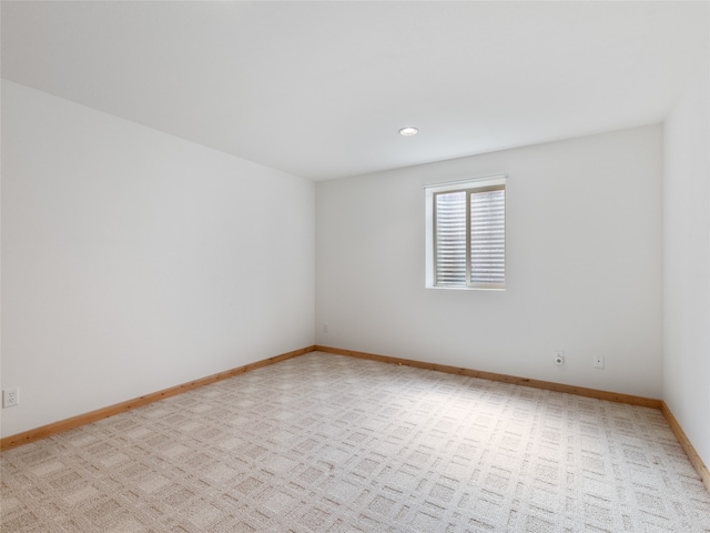 unfurnished room featuring light carpet