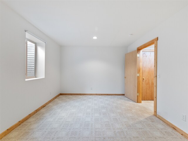 spare room featuring light colored carpet