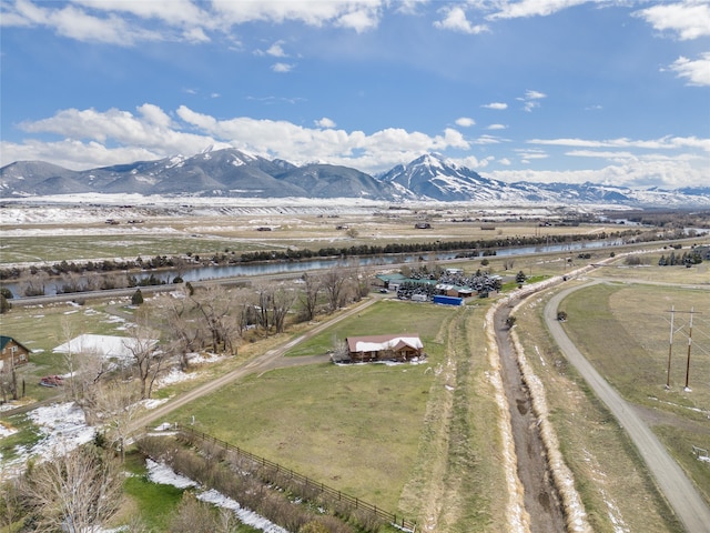 drone / aerial view featuring a rural view and a water and mountain view