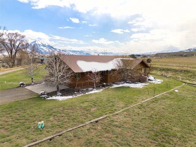 exterior space featuring a yard and a mountain view