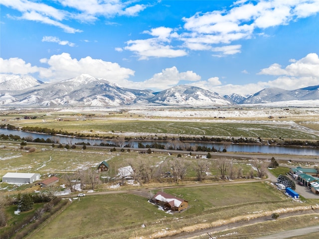 drone / aerial view featuring a water and mountain view