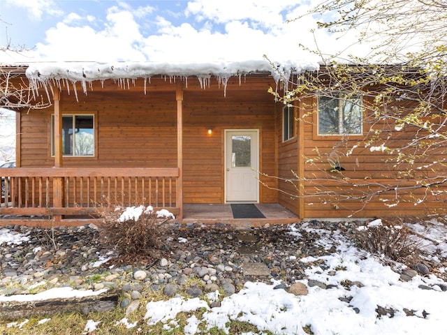 view of snow covered property entrance