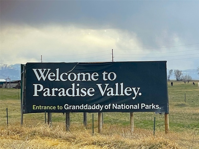 community / neighborhood sign featuring a rural view