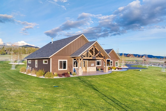 back of property featuring a patio area and a lawn