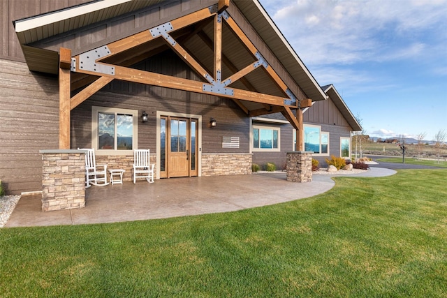 828AND806 Corvallis Hills Dr, Corvallis, MT 59828 - back of property with a yard, a patio area, and stone siding