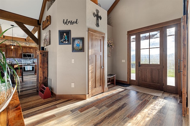 foyer featuring high vaulted ceiling, wood-type flooring, and beam ceiling