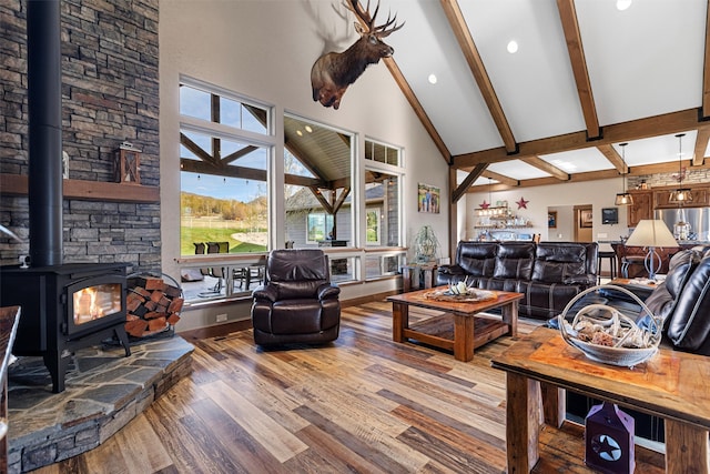 living room with high vaulted ceiling, a wood stove, wood-type flooring, and beam ceiling