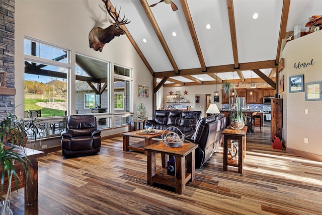 living room with high vaulted ceiling, ceiling fan, hardwood / wood-style flooring, and beam ceiling