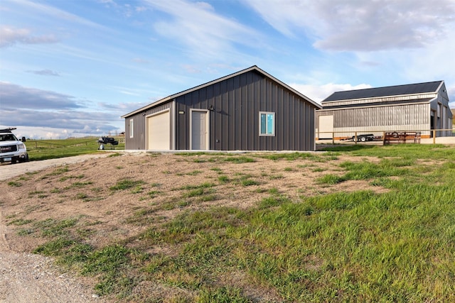828AND806 Corvallis Hills Dr, Corvallis, MT 59828 - view of property exterior with board and batten siding, an outdoor structure, a detached garage, and a pole building