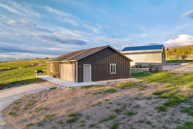 view of shed / structure featuring a rural view and a garage