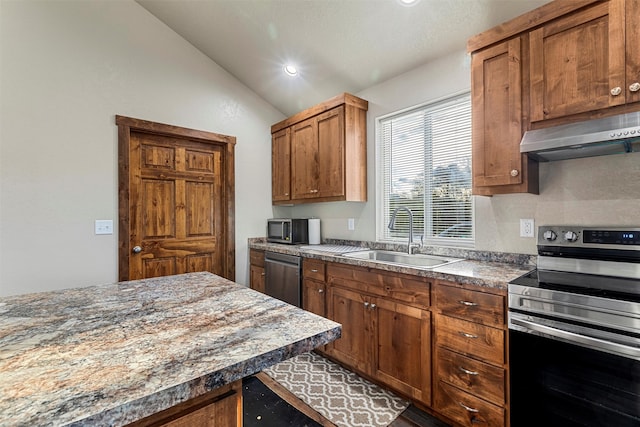 kitchen featuring vaulted ceiling, sink, and stainless steel appliances