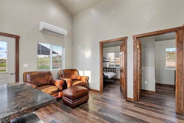 living room featuring high vaulted ceiling, a wall mounted AC, and dark hardwood / wood-style flooring