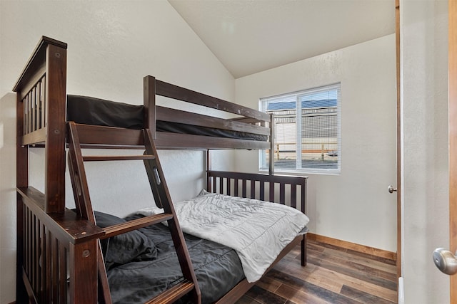 bedroom featuring wood-type flooring and vaulted ceiling