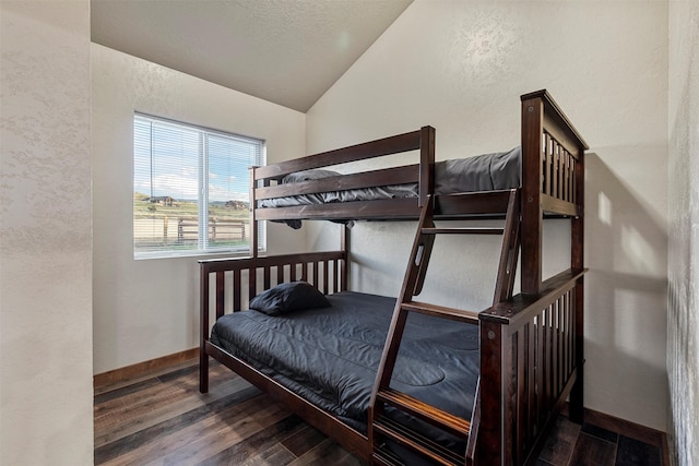 bedroom featuring dark hardwood / wood-style flooring and vaulted ceiling