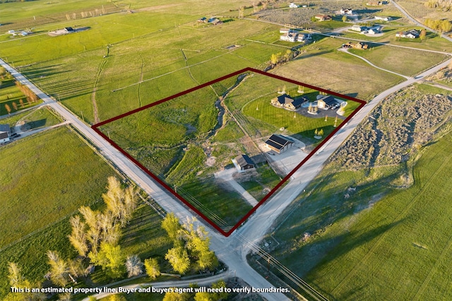 birds eye view of property featuring a rural view