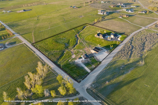 birds eye view of property with a rural view