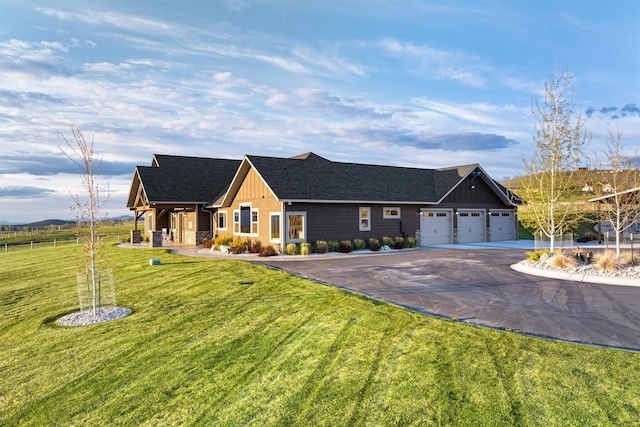 view of front of house with a garage and a front yard