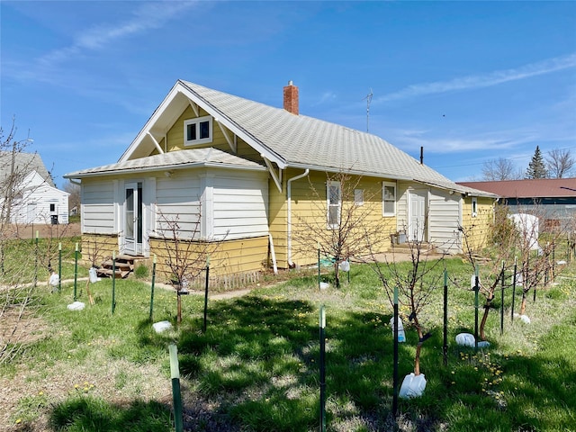 view of property exterior with a lawn