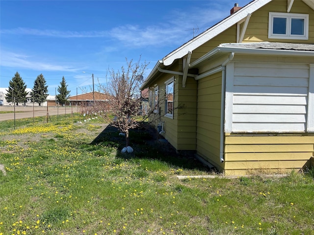 view of side of home featuring a yard