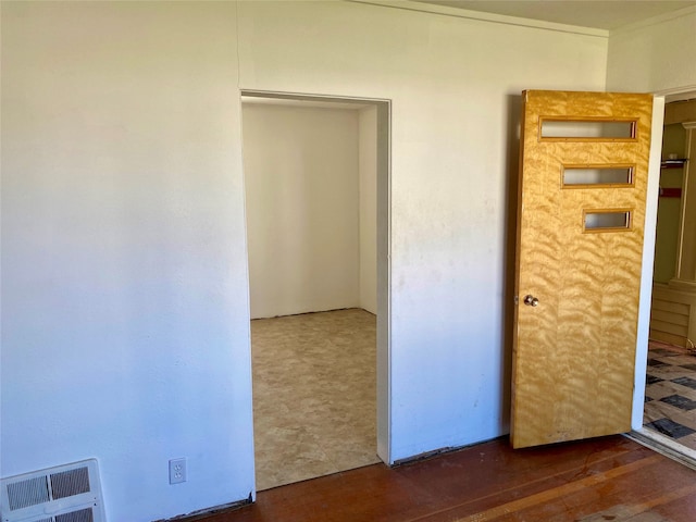 unfurnished bedroom featuring dark tile floors and a closet