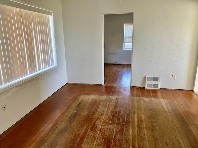 unfurnished room featuring dark wood-type flooring