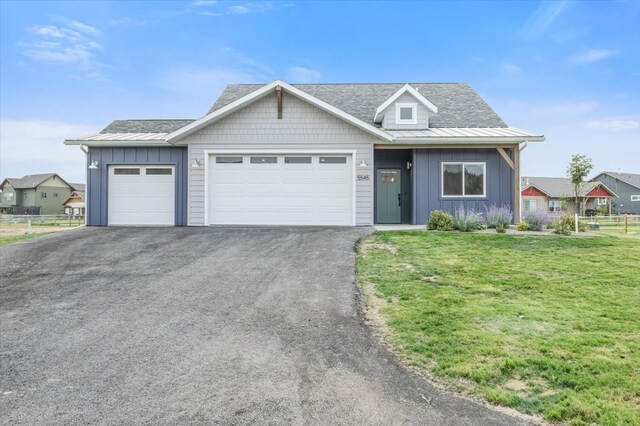 view of front of home with a front yard and a garage