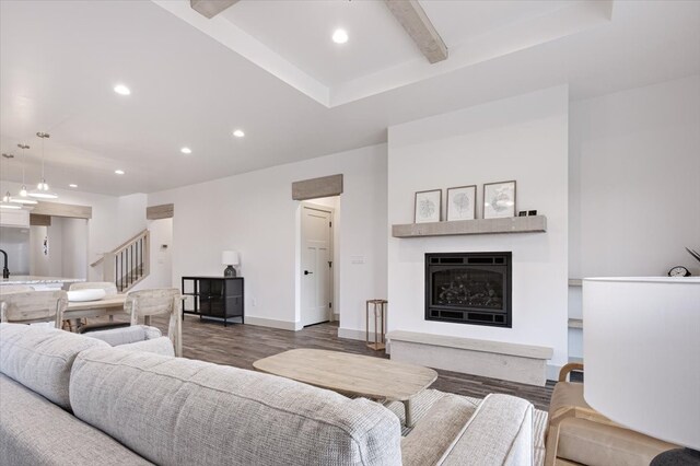 living room featuring hardwood / wood-style flooring and beam ceiling