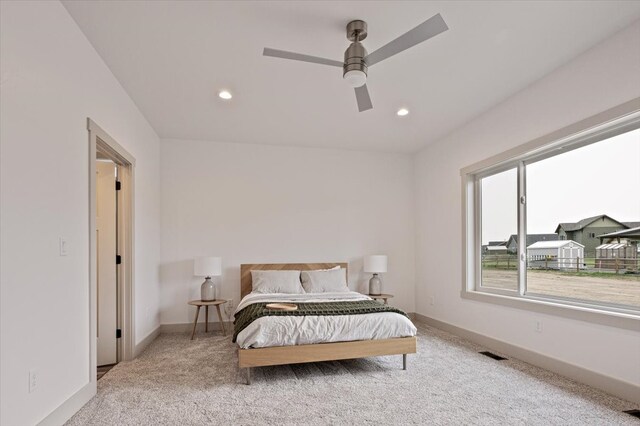 bedroom featuring ceiling fan and light carpet