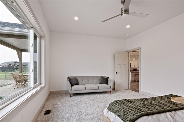 bedroom featuring ceiling fan and light carpet