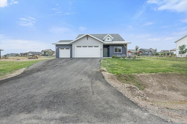 view of front of home with a garage and a front lawn