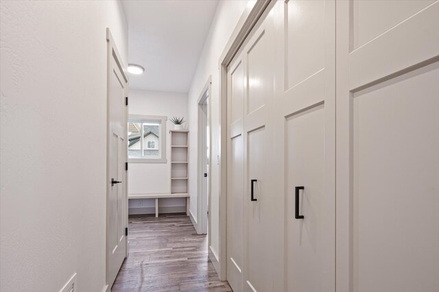 hallway with hardwood / wood-style flooring