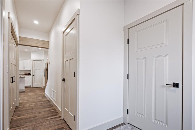 hallway featuring dark hardwood / wood-style flooring