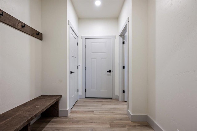 mudroom with light hardwood / wood-style flooring