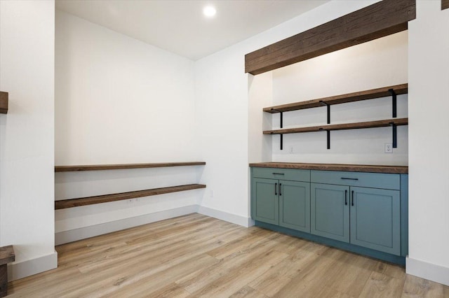 bar with light hardwood / wood-style flooring