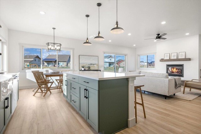 5539 Fireweed Loop, Helena, MT 59602 - kitchen featuring a glass covered fireplace, recessed lighting, light wood-type flooring, and light countertops