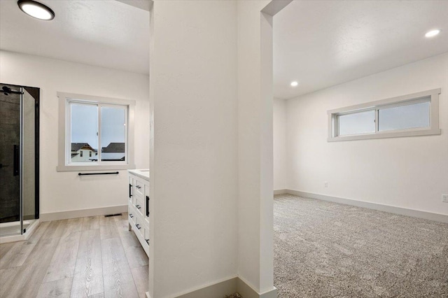 corridor with light hardwood / wood-style flooring