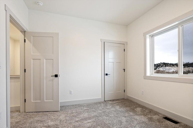 unfurnished bedroom featuring light colored carpet